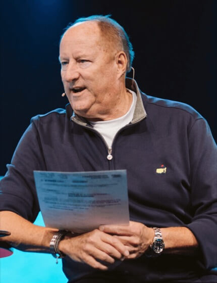 Ray Johnston speaking on stage